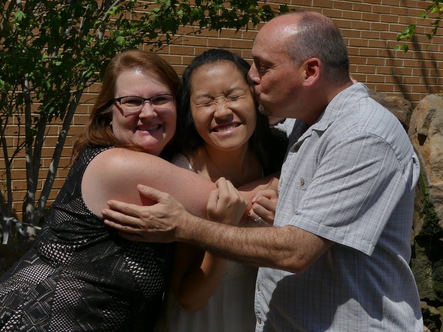 Coppell High School senior Mia Hermans with her mother, Chris, and her father, Bruce. They adopted her from the Chinese city of Maoming when she was a baby.