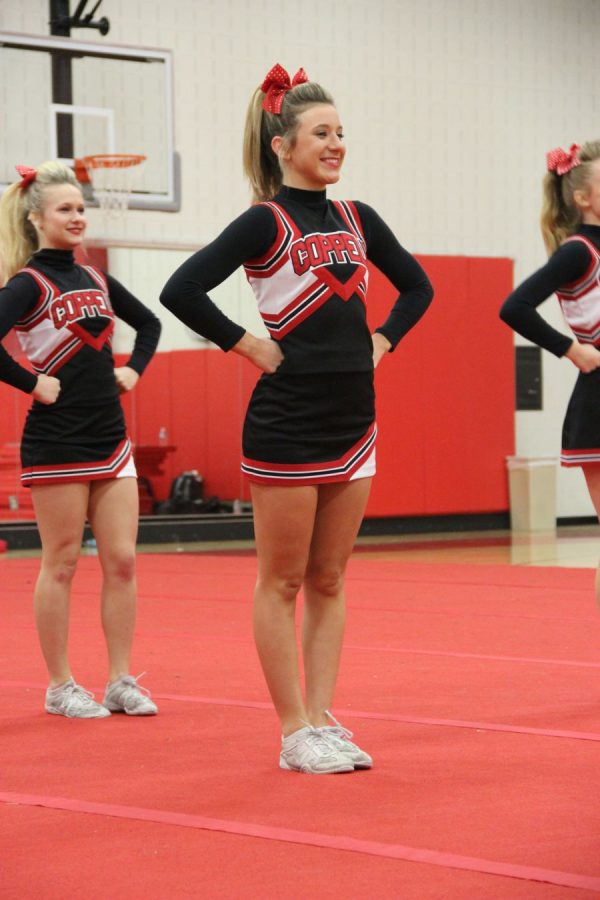 Coppell High School senior Avery Mullins leads the varsity squad to perform their routine before NCA nationals in the CHS small gym on Wednesday night. Varsity cheer will be competing the the NCA national competition this upcoming weekend at the Dallas Convention Center. 
