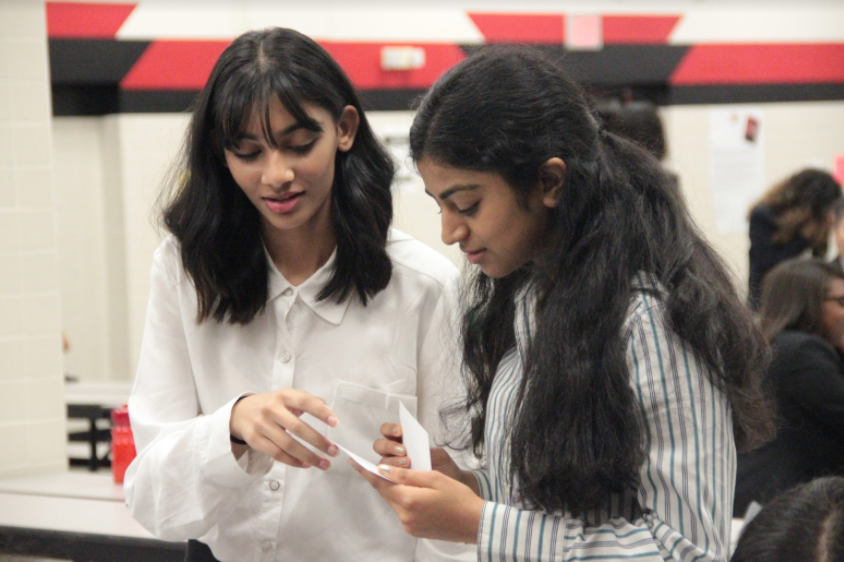 Coppell+High+School+junior+DECA+co-presidents+Anita+Kalahasti+and+Lekhitha+Ammaresh+review+cue+cards+in+preparation+for+their+event+round.+On+Saturday%2C+DECA+members+competed+in+their+annual+regionals+tournament%2C+a+business+and+marketing+based+competition+where+the+top-ranking+10+percent+will+advance+to+state.