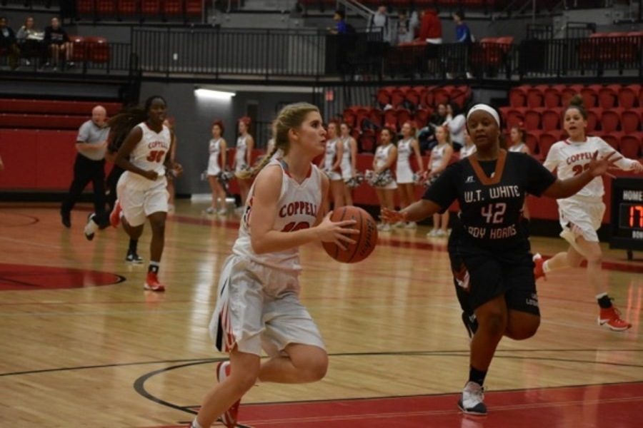 Coppell High School junior Mary Luckett goes up for a layup during the first quarter of Friday nights game in the CHS arena. The Cowgirls defeated W.T White, 62-11.
