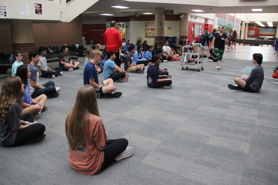 Coppell High School AP psychology teacher Kristia Leyendecker’s third period class does yoga in main hallway at Coppell High School. Kristia Leyendecker constructs her students in different yoga positions while Eric Walker walks around and monitors. 