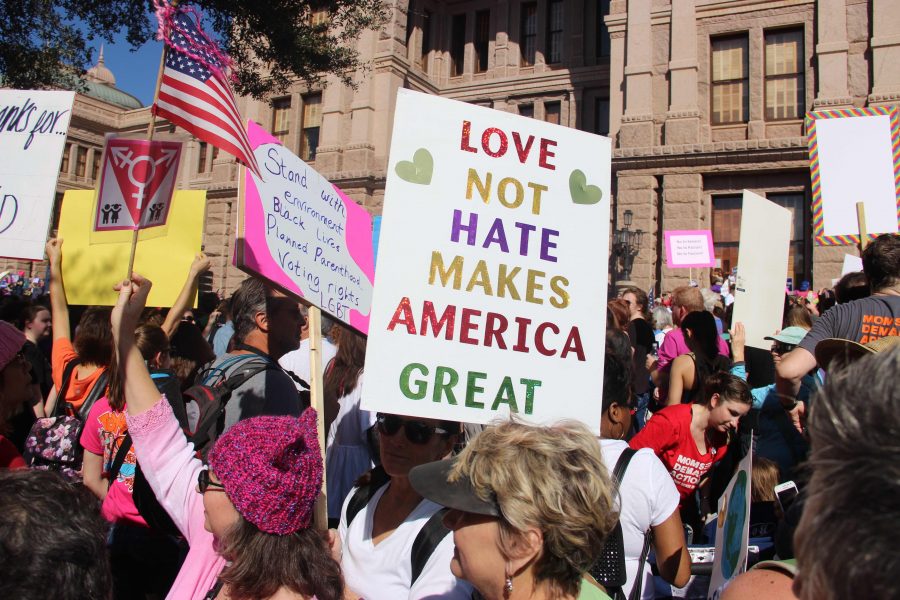 A woman holds a handmade sign while marching down West Congress Avenue during the Women’s March on Austin on Jan. 21. The march began at the Capitol, where a crowd of 50,000 people gathered in advocacy of women’s rights and civil rights. Photo by Meara Isenberg.