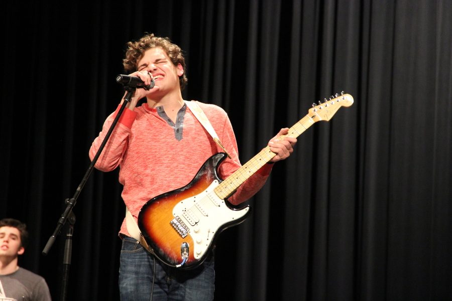 Coppell High School senior Eric Loop sings with his band Auto at the CHS talent show on Friday night in the auditorium. Over 15 acts performed at the show and the audience voted on the winners.