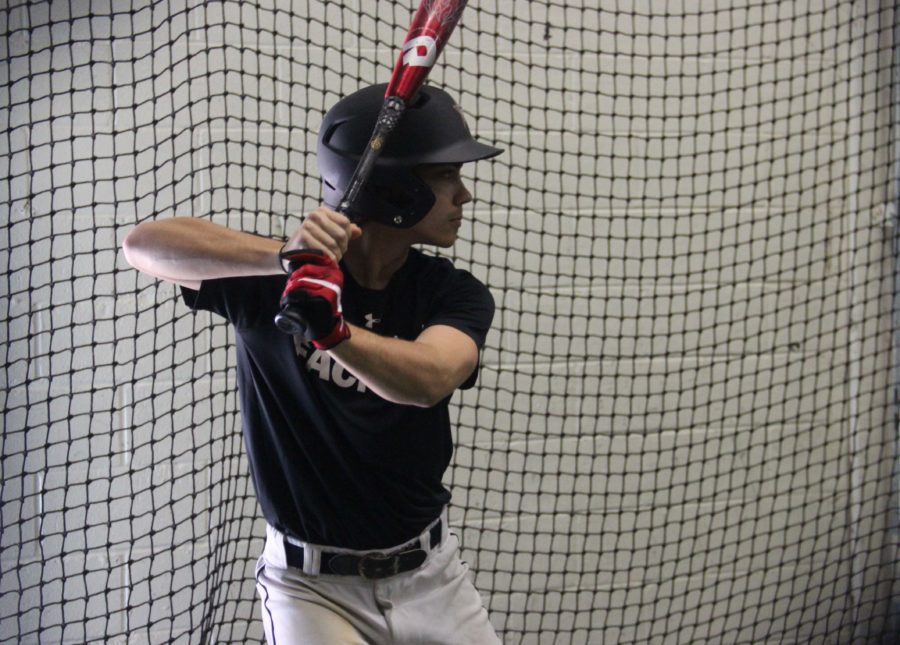 Coppell High School senior Tyler Lozes awaits a pitch in the batting cage at the CHS batting cages on Feb. 21 during fourth period. Lozes, an outfielder, for the Cowboys, is on the Varsity Boy’s baseball team.
