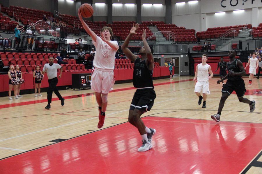Coppell+High+School+senior+Caden+Horak+shoots+a+layup+during+the+game+against+Berkner+on+Tuesday+night+in+the+CHS+arena.+Cowboys+fell+to+the+Rams%2C+52-47%2C+falling+behind+in+the+last+few+minutes+of+the+game.+