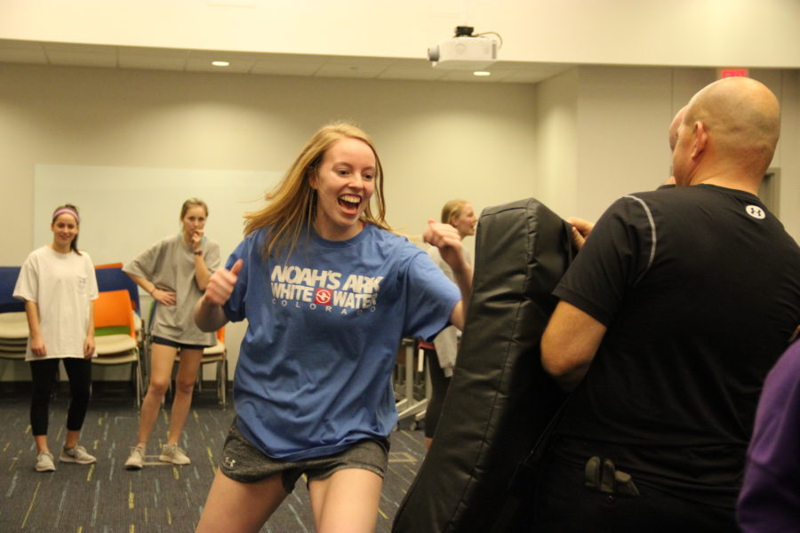 Coppell High School senior Katie Herklotz practices self defense by punching a padded shield held by a Coppell police officer. Senior girls attending CHS and New Tech High@Coppell were offered a free safety course to prepare them for being on their own in college. 