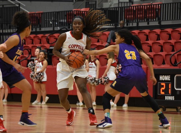 Coppell High School junior Rachel Okereke gets past Richardson’s defense during Friday night’s game in the CHS arena. The Cowgirls fell to the Lady Eagles 55-52 to move on with a record of 6-6 District 9-6A, 19-12 overall.
