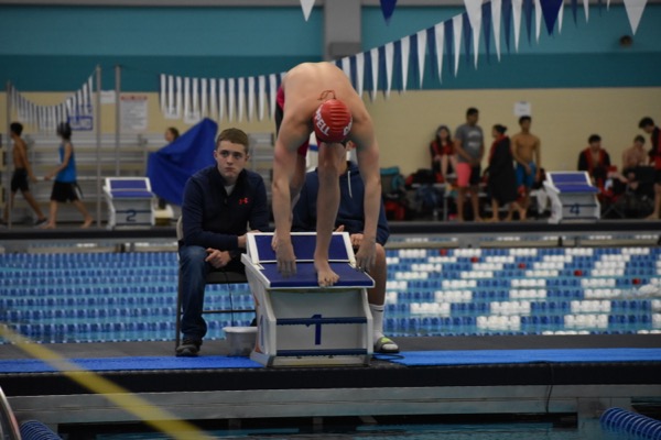 Coppell senior Jonathan Henley prepares to jump off of his platform for the 100 freestyle heat on Saturday morning in the Lewisville ISD Westside Aquatic Center. The swimming team placed fourth overall at the regional meet.