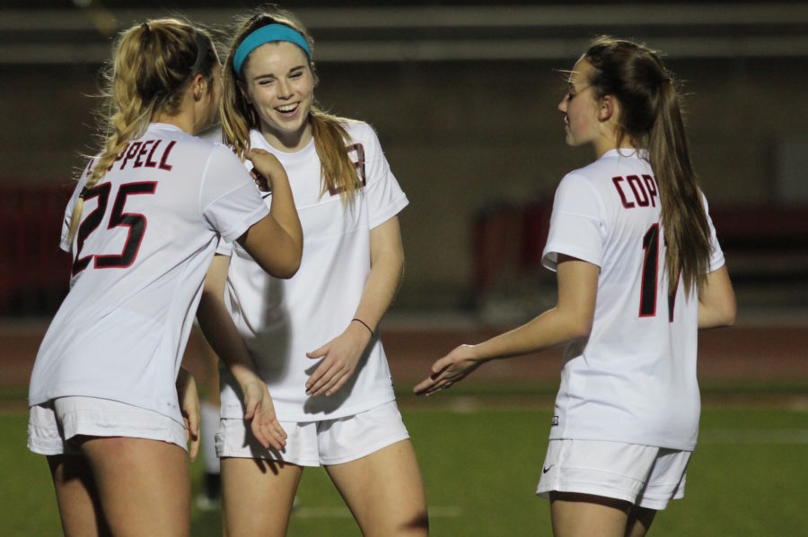 Coppell High School junior Ty Runnels, senior Sarah Houchin, and freshman Haley Roberson (left to right) celebrate their third goal of the night during the first half of Friday night’s game at Buddy Echols Field. Coppell claimed a 7-0 victory over Berkner. 
