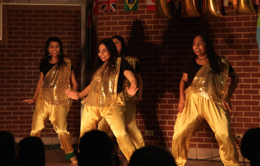 Students Bollywood dance during the Coppell High School Junior World Affairs Council (JWAC) annual Heritage Night on Friday  in the CHS commons. From hip-hop to bollywood dancing, the night of performances aims to celebrate the cultural and ethnic diversities present in the CHS student body through music and dance. Photo by Kelly Wei.