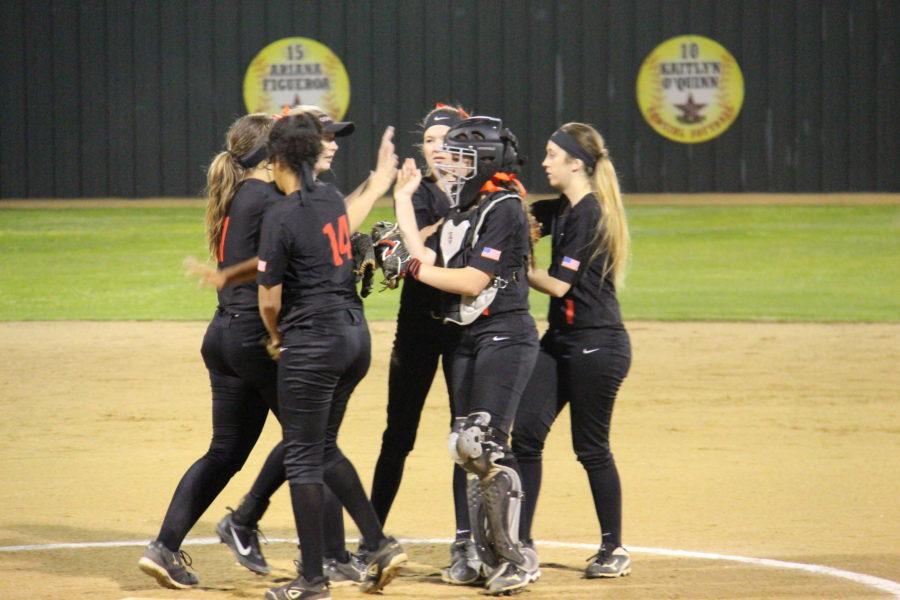 The Coppell Cowgirls come together on the field during the second inning of Friday night’s District 9-6A opener against Richardson Pearce. The Cowgirls defeated the Lady Mustangs, 8-5.