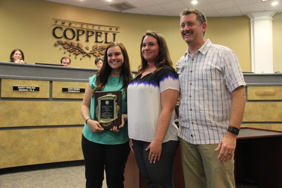 Ellis & Associates representative Steve Miller presents the Platinum International Aquatic Safety Award to CORE representatives Lauren Sutton (left) and Kara Lungren (right) Tuesday night at City Hall. During the city council meeting, this award was presented to the CORE to acknowledge their success in lifeguard training. Photo by Hannah Tucker.