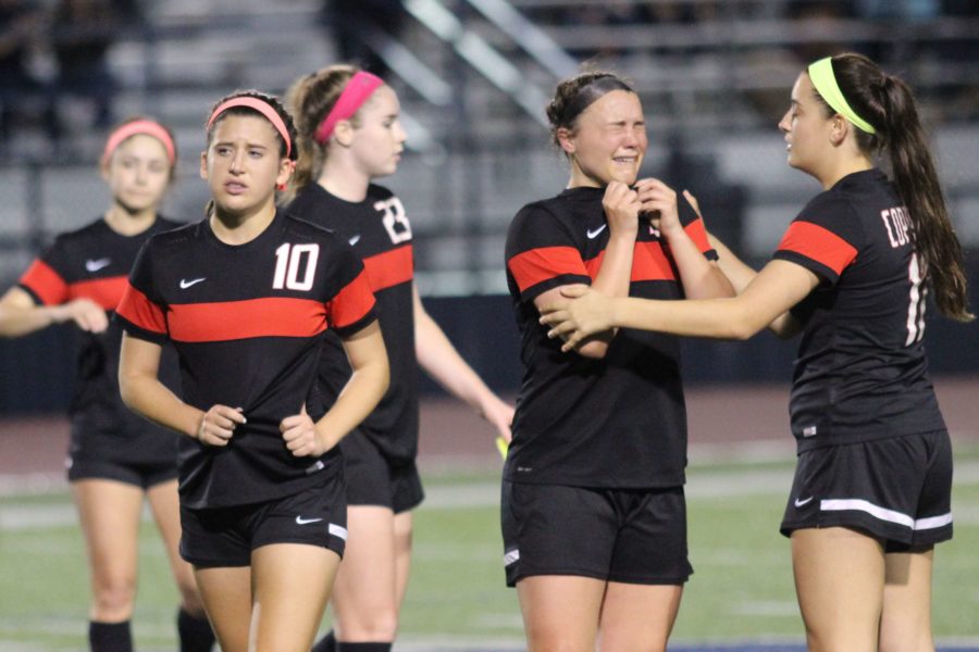 Coppell High School freshman defender Haley Roberson, senior forward Tori Teffeteller, senior defender Sarah Houchin and sophomore midfielder Mary Ziperman all accept defeat after their 1-0 loss to the Sachse Lady Mustangs at Ron Poe Stadium. After a weather delay that lasted over an hour, the Cowgirls could not pull out a victory in the Class 6A Region II quarterfinals.