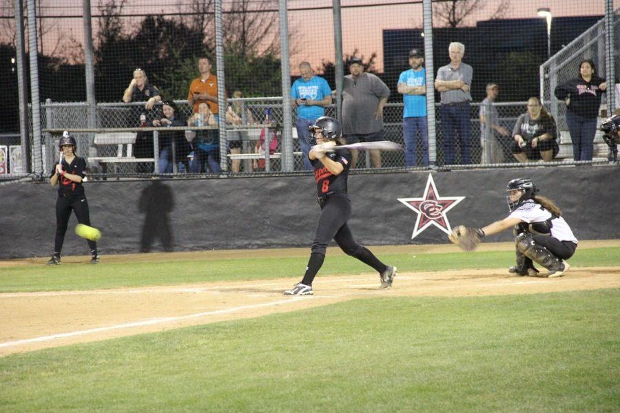 Coppell High School freshman pitcher Abigail Weeden hits a grounder to second base as she runs to first during Friday night’s game at the CISD Baseball/Softball Complex. Coppell Cowgirls beat Bishop Lynch 15-0. 