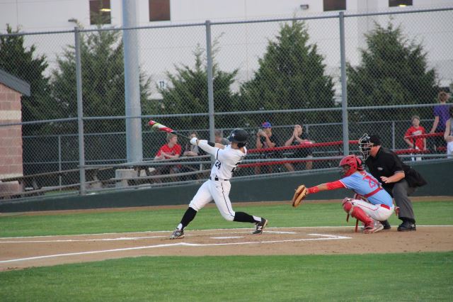Coppell High School sophomore Blake Jackson strikes a two RBI double during second inning of Tuesday night’s game against Skyline. The Coppell Cowboys beat the Raiders, 17-0, at the CISD Baseball/Softball Complex.