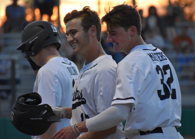 Coppell High School seniors Austin Gross and Cody Masters celebrate Gross’ two-run home run on during the first inning of Friday night’s game. The Cowboys defeated W.T. White with a final score of 11-1 at the Coppell ISD Baseball/Softball Complex. 

