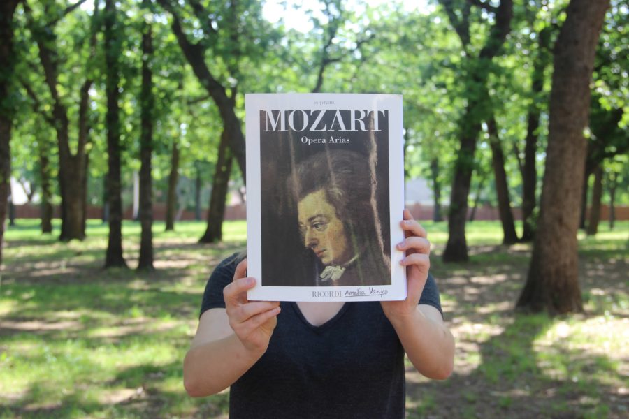Coppell High School junior Amelia Vanyo holds up her Mozart Opera Arias book out front of CHS. Vanyo has been singing for eight years and wants to study vocal performance in college. Photo by Bren Flechtner.
