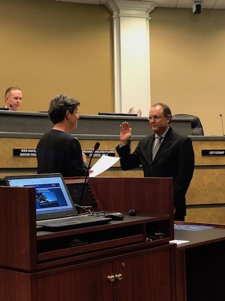 Coppell city mayor swears in Mike Land as the new city council manager on April 11 at the town hall. The rest of the evening was spent celebrating the library’s excellence and approving city expenditure projects. Photo by Emma Cummins. 