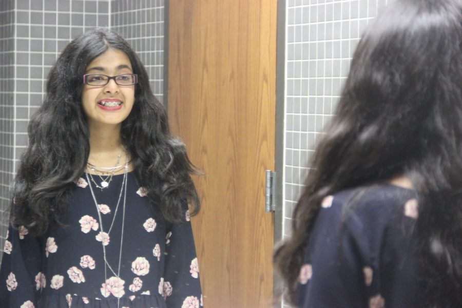 Coppell High School senior Saira Haque stares into a mirror as she learns to embrace her features and love her insecurities. Growing up Haque was in embarrassment of her curly hair, but with time has come to appreciate it. 