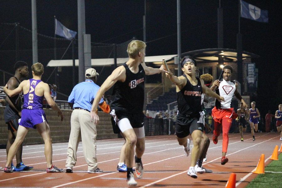 Coppell+High+School+senior+Matt+Dorrity+passes+the+baton+to+senior+Zach+Dicken+in+the+Men%E2%80%99s+4x400+Relay+Finals+of+the+UIL+District+9-6A+Track+%26+Field+Championships+hosted+by+Jesuit+Dallas+at+Postell+Stadium+on+Tuesday+night.+The+Coppell+team+consisted+of+sophomore+Christian+Leffingwell%2C+junior+Gabriel+Lemons%2C+senior+Matthew+Dorrity+and+Dicken.+The+team+placed+second+in+the+event%2C+after+Dallas+Skyline%2C+with+a+time+of+3%3A24.37.