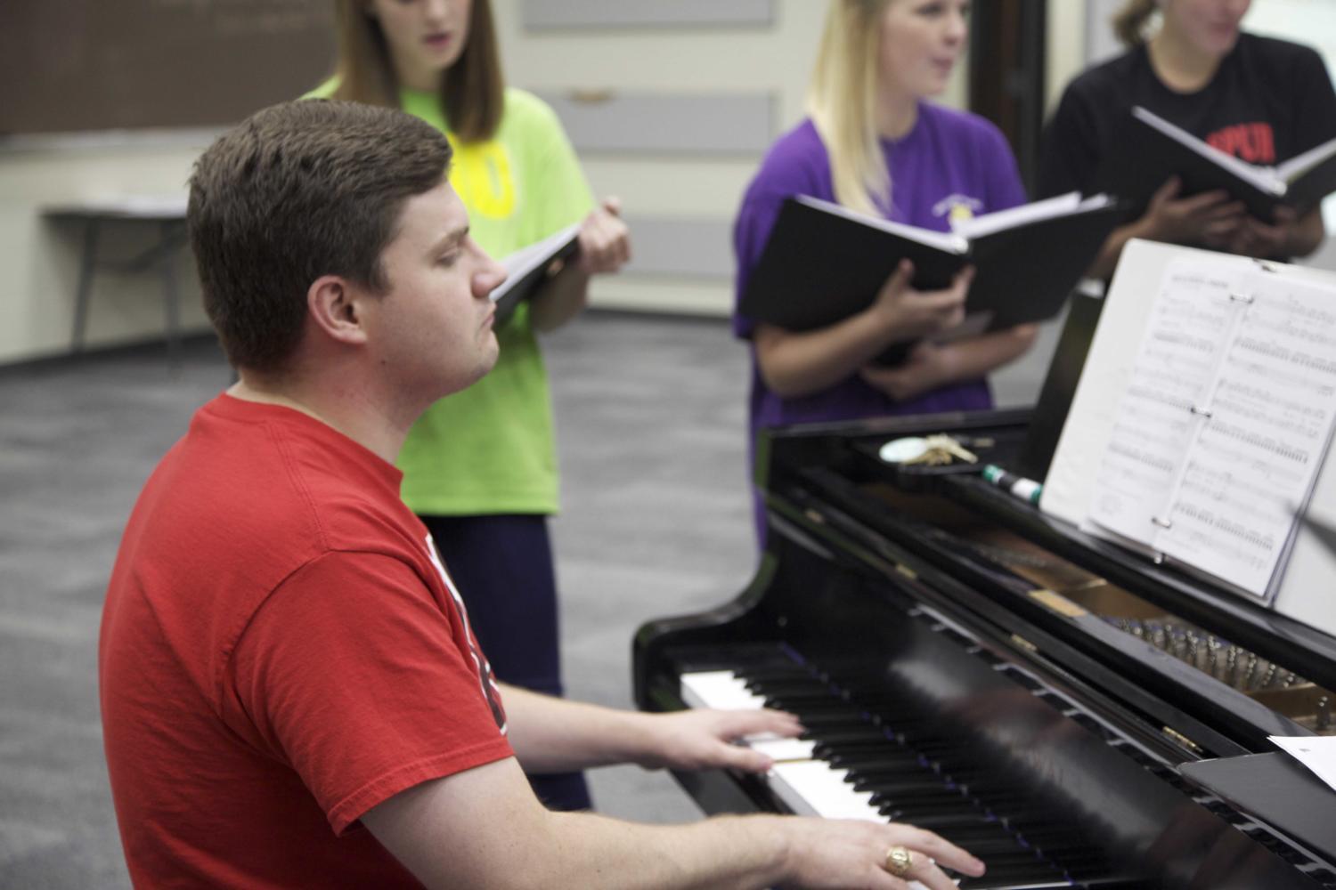 Choir director Josh Brown plays the piano at an after-school a cappella rehearsal at the start of the 2012-2013 school year. Since then, Brown has lead the choir program to numerous awards and national competitions. Sidekick file photo.