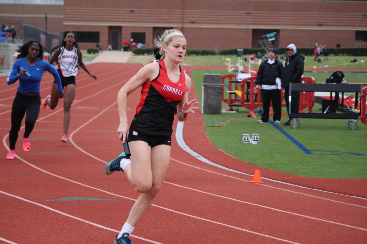 Coppell High School freshman multisport athlete Lauren Kellett runs a relay race at Buddy Echols Field during the Coppell Relays on March 4. Kellet won The Sidekick’s Freshman Athlete of the Year honors. Photo by Kelly Monaghan. 