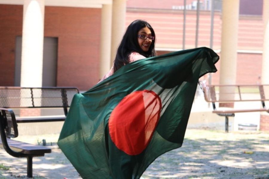 Coppell High School senior Saira Haque holds the national flag of Bangladesh, as she plans to intern at JAAGO Foundation, a nonprofit that helps combat the cycle of poverty through education. Haque plans to travel to Dhaka where the headquarters are located during the summer of next year.