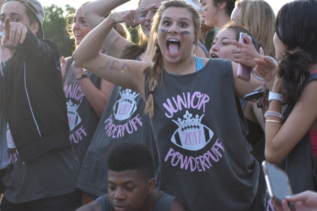 Coppell High School junior Grace Mobley cheers on the junior powderpuff team on Tuesday night at Wagon Wheel Park. Powderpuff is a tradition in which every year, the junior and senior girls play football against each other.