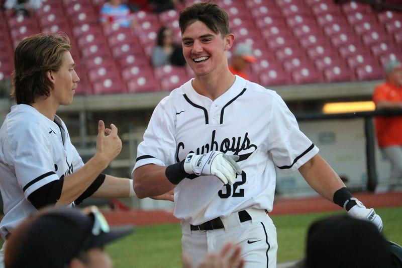 The Coppell High School varsity baseball team congratulates CHS senior Cody Masters after he scores the first run of Thursday night’s game against Naaman Forest. The Coppell Cowboys defeated the Naaman Forest Rangers 13-0 at the AirHogs Stadium. 