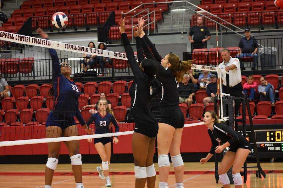 Coppell+High+School+junior+Amarachi+Osuji+and+freshman+Madison+Gilliland+jump+to+make+a+block+during+Friday+night%E2%80%99s+game+in+the+Arena.+The+Cowgirls+played+against+the+Allen+Eagles+and+ended+the+match+losing+straight+sets+%2827-29%2C+12-25%2C+20-25%29+against+the+Lady+Eagles.%0A
