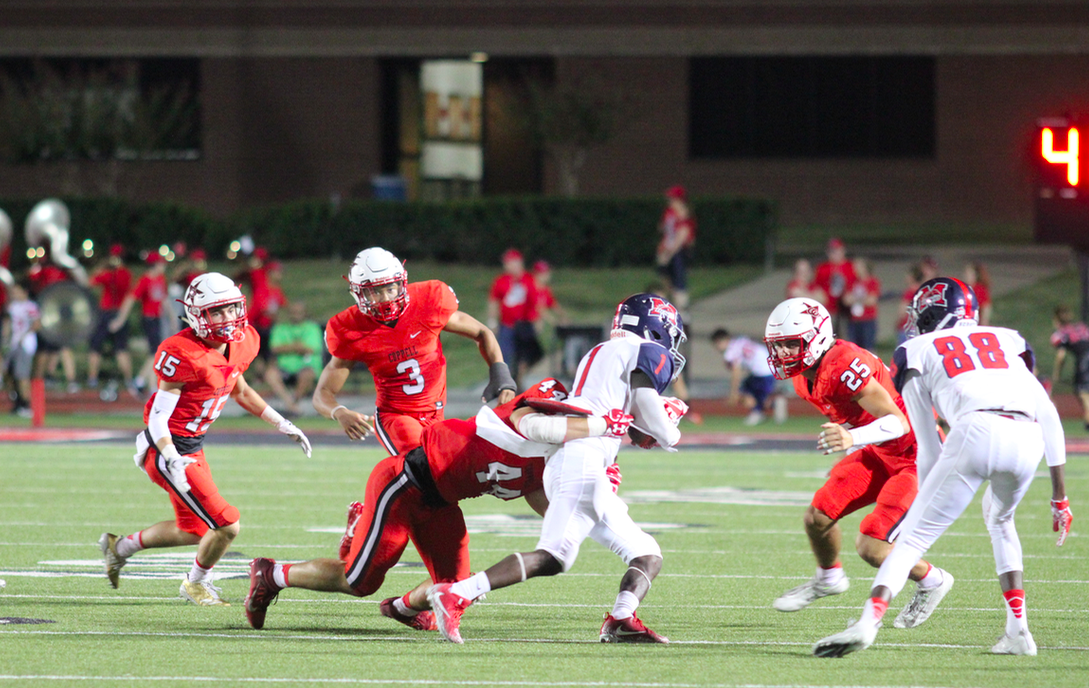 4. Coppell High School senior Pierce McFarlane tackles McKinney Boyd as they run the ball for a touchdown. Last nights game at Buddy Echols Field was a close game, but the cowboys went home with a win, 34-24. Photo by Bren Flechtner.
