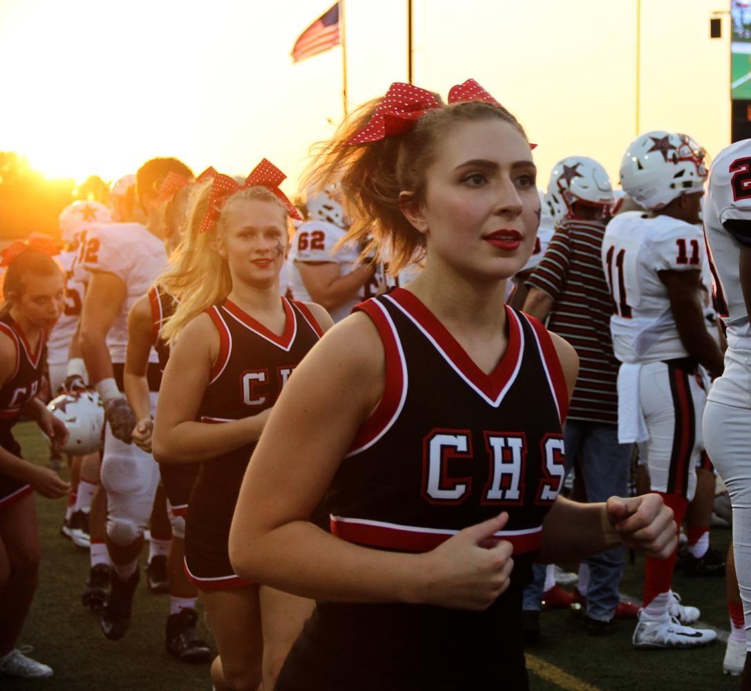 The cheerleaders run downfield after celebrating a Cowboy touchdown during the fourth quarter of Friday nights game at Pennington Field. The Cowboys won their first game of the season  58-23.