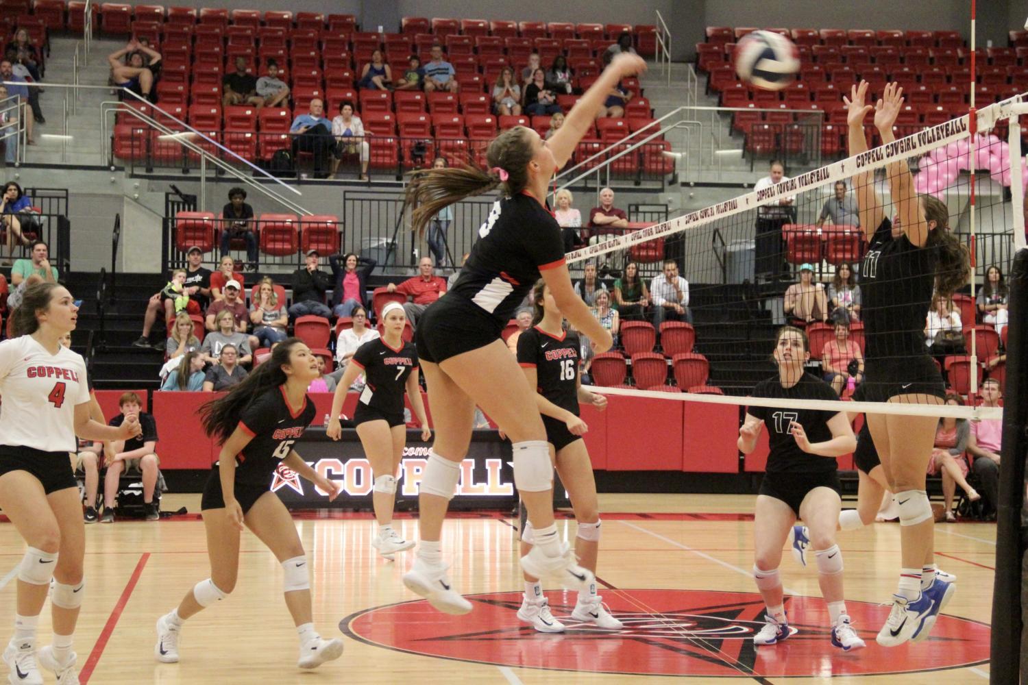 Coppell+High+School+senior+Breanne+Chausse+right+front+spikes+the+ball+during+the+match+at+the+Coppell+High+School+Arena+against+Pearce+on+Tuesday+night.+The+Cowgirls+defeated+the+Lady+Mustangs%2C+25-21%2C+25-23%2C+24-26%2C+25-14%2C+in+their+first+home+district+game.