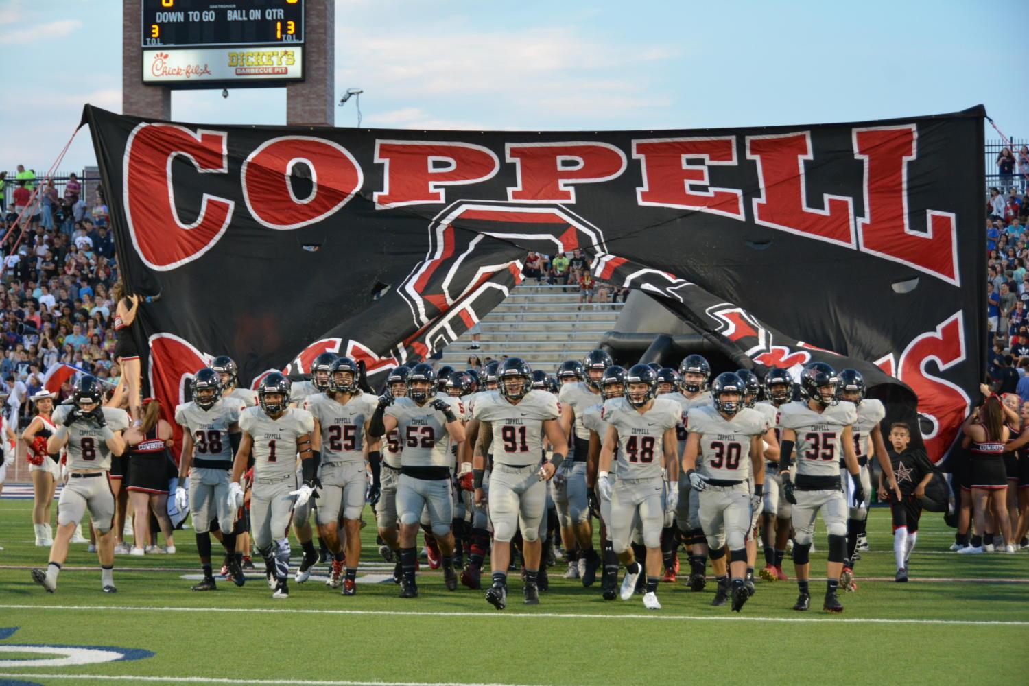 The Coppell Cowboys march their way out onto the field Friday night against the Allen Eagles. The Cowboys lost 35-23 to the state-ranked team.