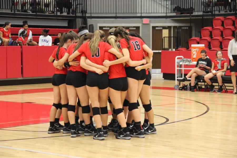 The+Coppell+High+School+varsity+volleyball+team+huddled+together+to+pray+before+their+game+against+the+Berkner+Lady+Rams.+The+Cowgirls+took+the+victory+and+won+all+three+sets+last+Tuesday+in+the+CHS+Arena.