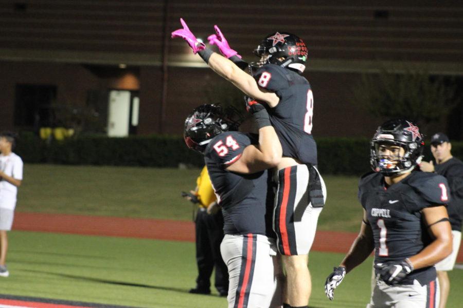 Coppell wide receiver Blake Jackson celebrates with lineman Mike Ruth after Jackson scores a touchdown on Friday night at Buddy Echols Field.  The Cowboys defeated the W.T. White Longhorns, 55-14, in District 9-6A play.