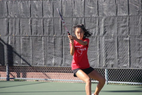 Coppell High School junior Suzuka Nishino makes a powerful hit. Coppell’s varsity tennis team won 10-0 against North Garland Tuesday afternoon in the playoffs.