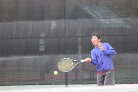 Coppell senior Naoya Matsumoto practices with the varsity team during eighth period at the CHS tennis center on a chilly afternoon today. The CHS varsity team won the District 9-6A tournament at CHS on Oct. 12.
