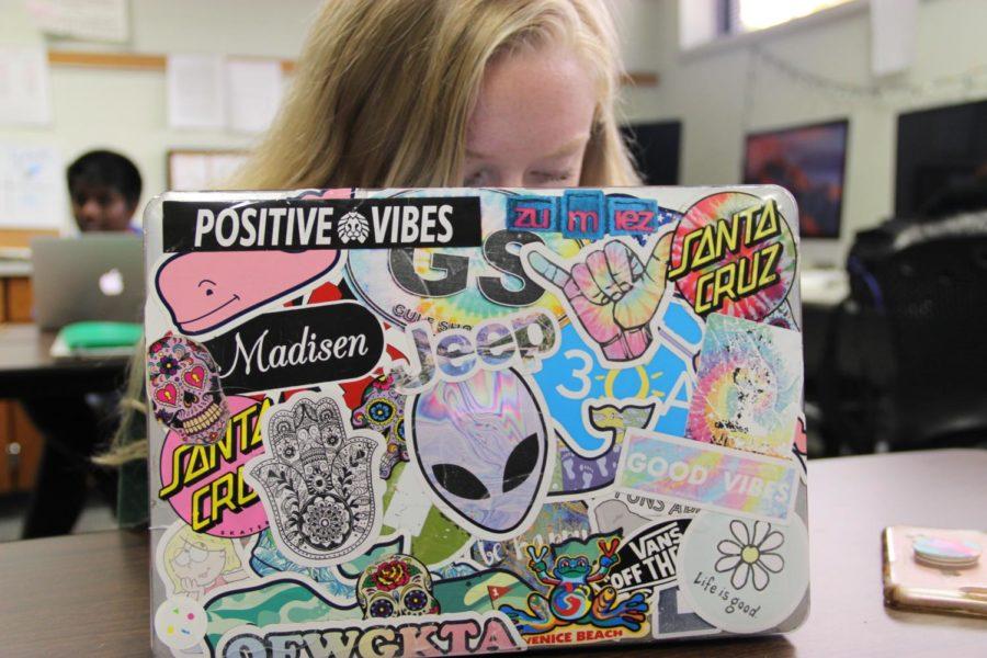 laptops with stickers on them