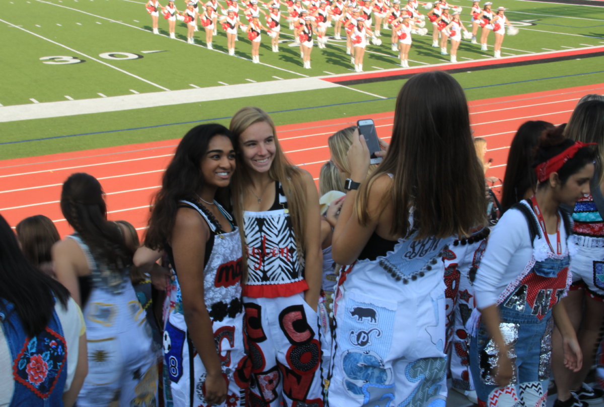 Coppell High School seniors Maya Joseph and Payton Kirk pose on Sept. 8 during the first pep rally of the year wearing their senior overalls. Senior overalls are worn during the school day before Friday night home football games and have been a tradition among schools in Texas.