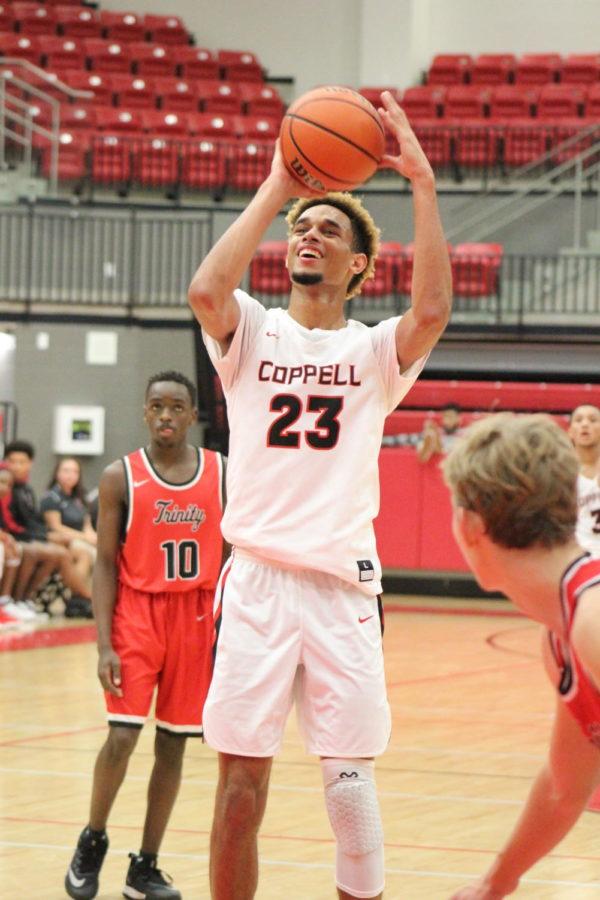 Coppell High School sophomore forward Quevian Adger shoots a free throw during the game against the Trinity Trojans at the Coppell High School Arena on Nov. 29. The Coppell Cowboys defeated the Trinity Trojans, 58-49.