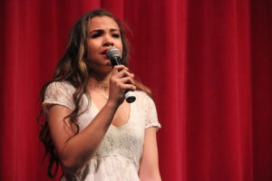Coppell High School junior Kealani Garrett sings a solo for the second performance of the night. Coppell High School girls choir performs their second performance of the Respira Dessert Show Saturday night in the auditorium. 