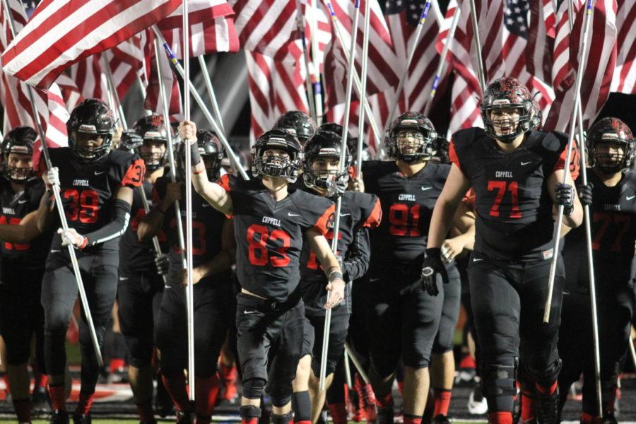 The Coppell Cowboys march out with American Flags before the game on Nov. 10 at Buddy Echols Field. The Cowboys commemorate the men and women that dedicate their lives to the United States for Veterans Day.