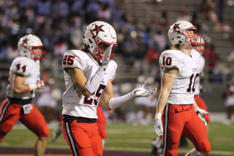 Coppell+Cowboys+junior++safety+Justin+Murray+congratulates+the+team+after+the+Cowboys+scored+their+first+touchdown+during+the+first+quarter+on+Nov.+3+at+Forester+Stadium.+The+Coppell+Cowboys+defeated+the+Skyline+Raiders+31-19.+