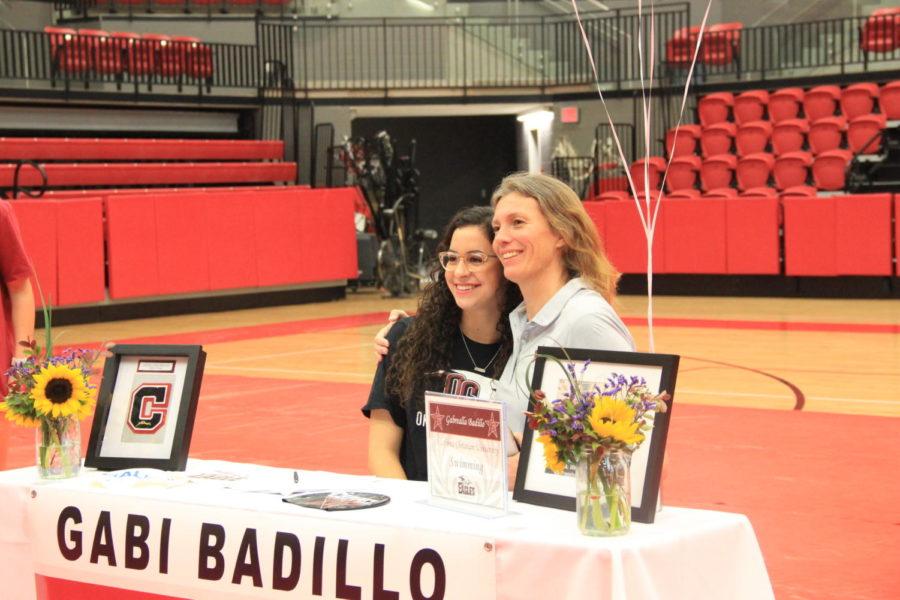 Coppell+High+School+senior+Gabi+Badillo+smiles+for+the+camera+with+her+coach+after+signing+with+Oklahoma+Christian+University+on+National+Signing+Day.+Students+are+signing+their+letters+of+intent+for+the+college+they+intend+to+play+for+in+the+upcoming+year.%0A