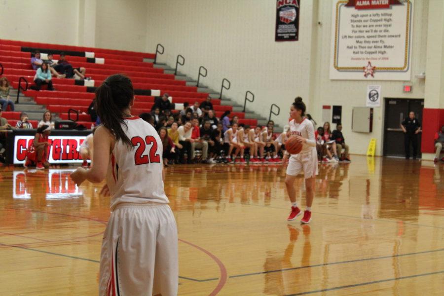 Coppell sophomore guard Kennedi Rogers and the rest of the Cowgirls play offense against Lake Highlands Friday night at CHS. Coppell opened District 9-6A play with a 40-32 victory over the Lady Wildcats.