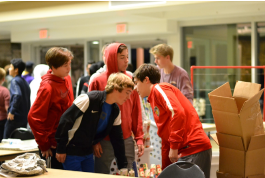 Coppell Cowboys soccer team volunteers to carry boxes of wrapping paper and other
supplies on Dec. 6 at Valley Ranch Baptist Church in order to pack toys for children in need. Coppell High School JV and Varsity soccer teams volunteered to help give back to the local community and disadvantaged children.
