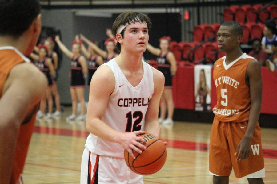 Coppell High School senior JB Pietrowiak shoots at the free throw line during the second quarter of Friday nights game in the arena. The varsity boys basketball team played against WT White taking the win with a score of 74-52.