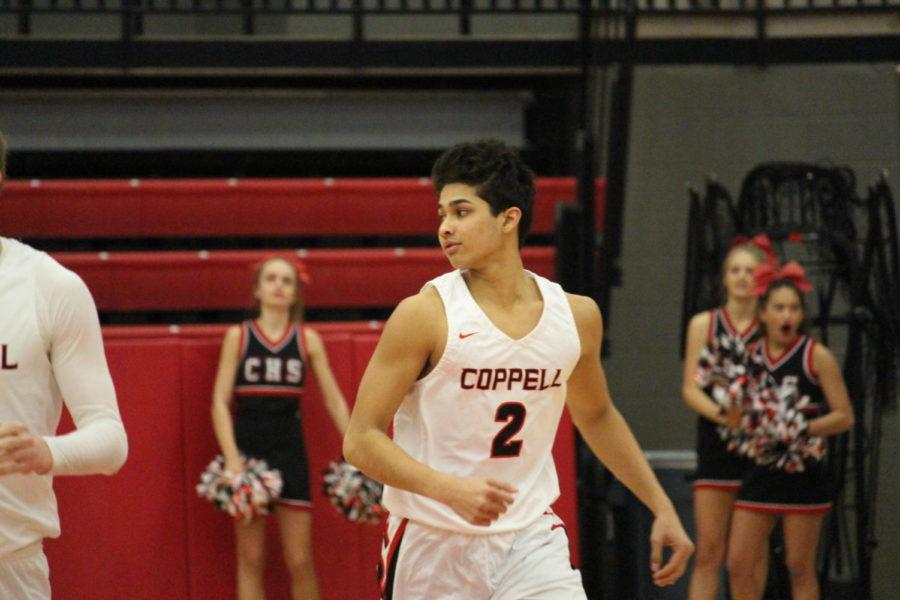 Coppell High School senior Prathik Tangarala runs to the other side of the court after making a three pointer during the fourth quarter of Friday nights game in the arena. The varsity boys basketball team played a home game against WT White high school taking the win with a score of 74-52.