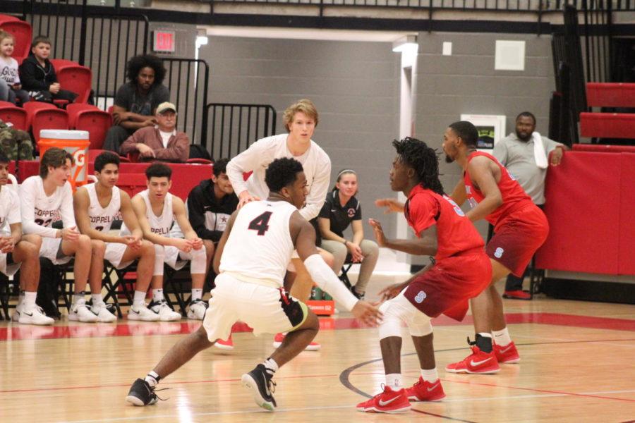 Coppell High School freshman point guard KJ Liggins plays offense during the game against the Skyline Raiders at the Coppell High School Arena on Jan. 9. The Coppell Cowboys defeated the Skyline Raiders, 81-59.